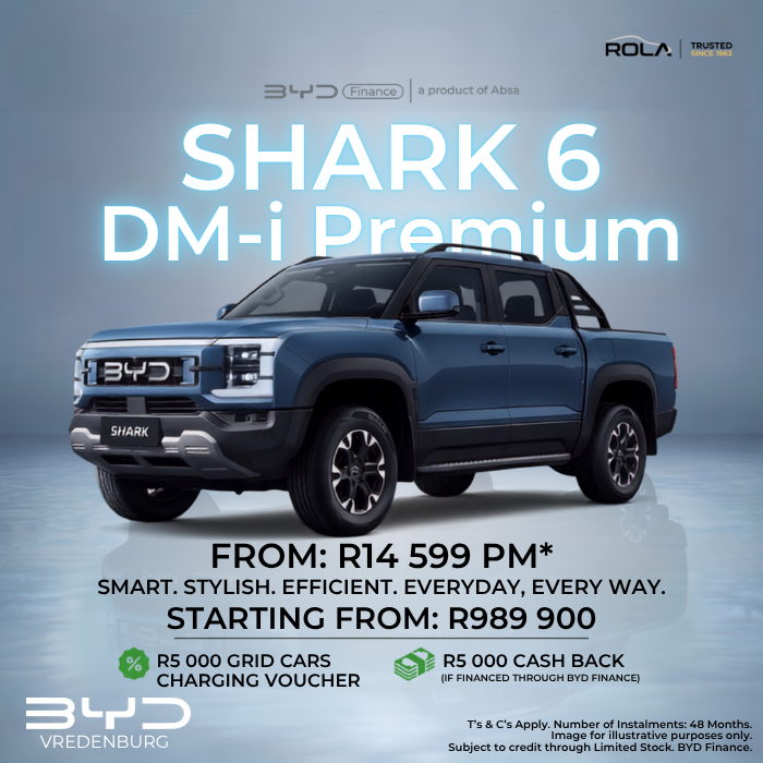 Blue BYD SHARK 6 DM-i Premium plug-in hybrid bakkie on a studio background, promoting finance from R14,599 per month or pricing from R989,900. Offer includes a R5,000 GridCars charging voucher and R5,000 cash back through BYD Finance. Available at Rola BYD Vredenburg.